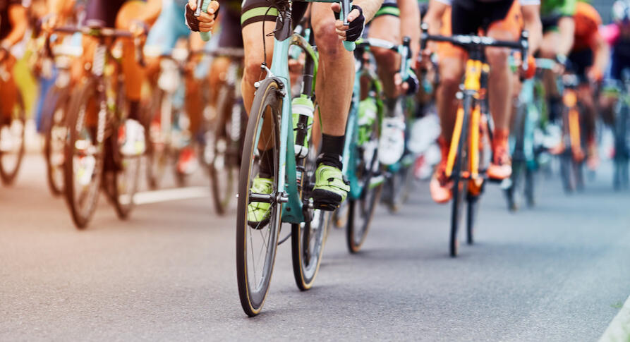 Cyclist racing in a fast group, showing how race positioning, decision-making and repeated surges can affect performance even when training fitness is strong.